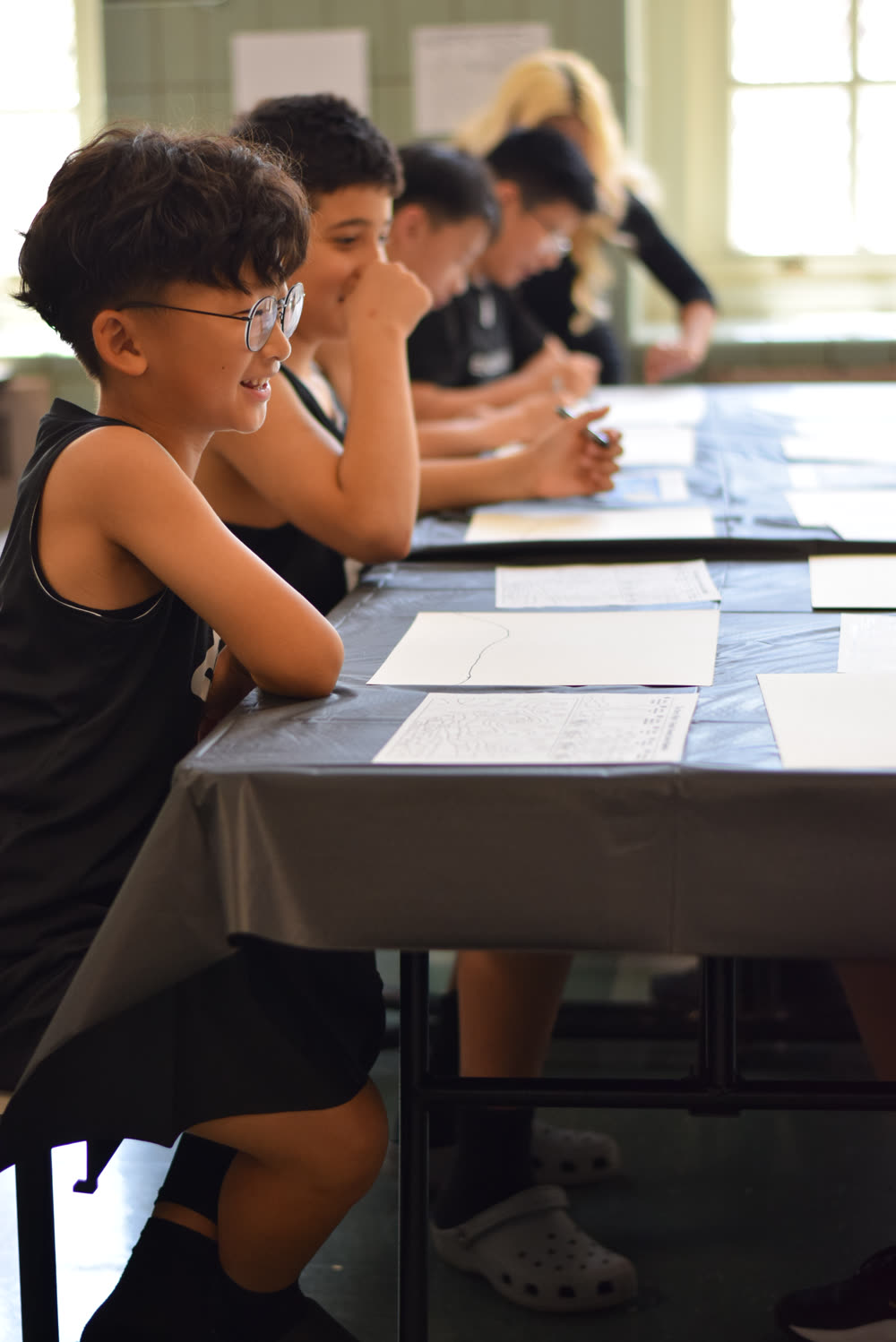 Kids painting at tables during an art party
