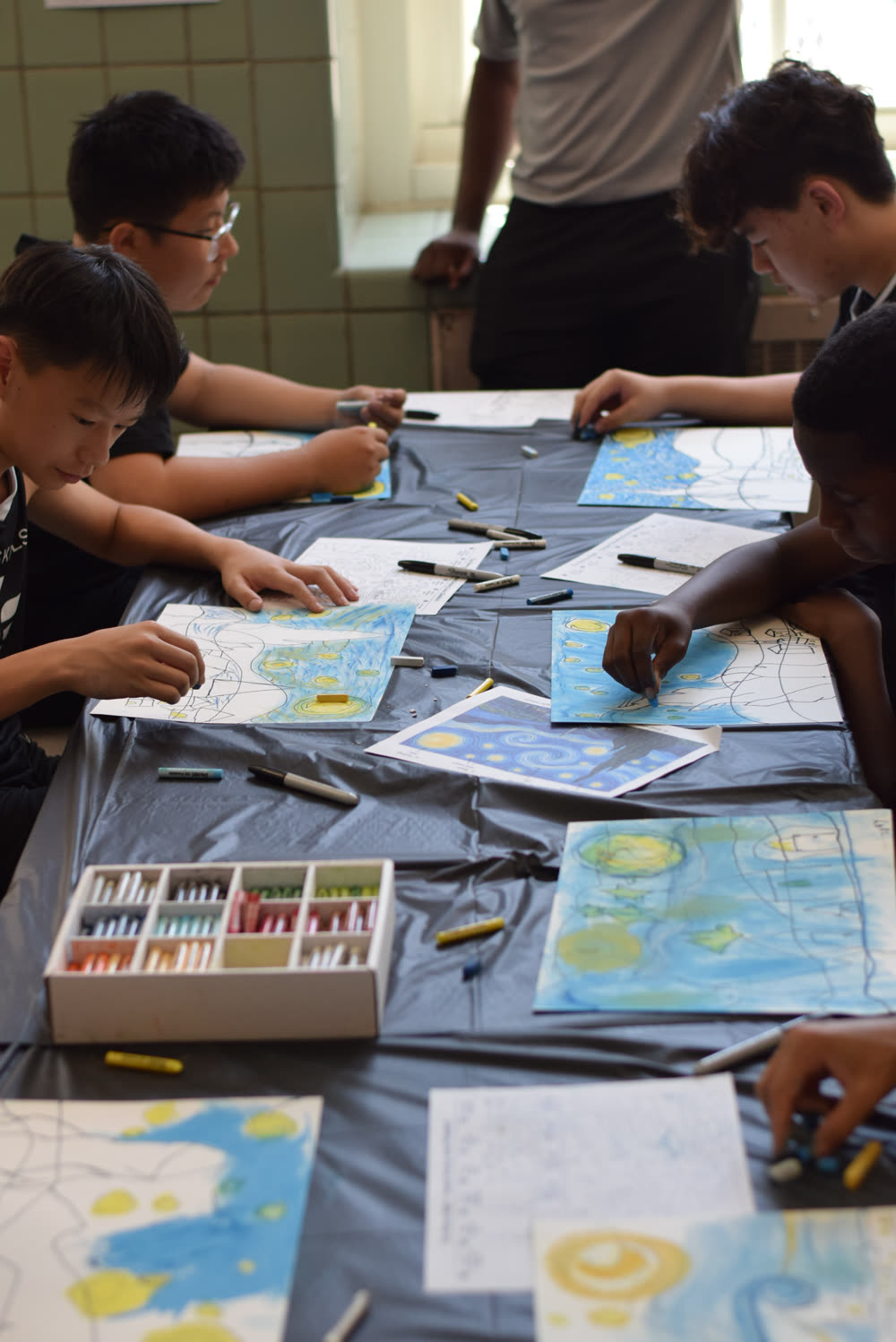 Kids working on art projects at an Elite Skills art party