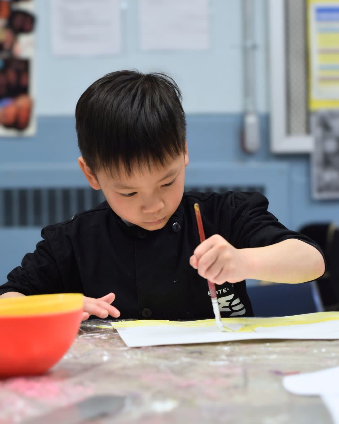 Camper painting at art camp