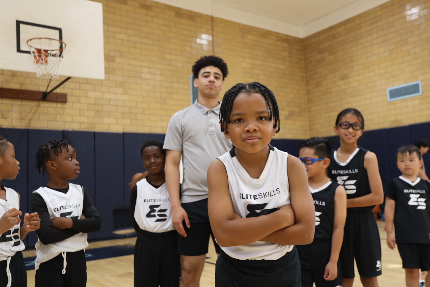 Elite Skills coach with a group of young players in the gym